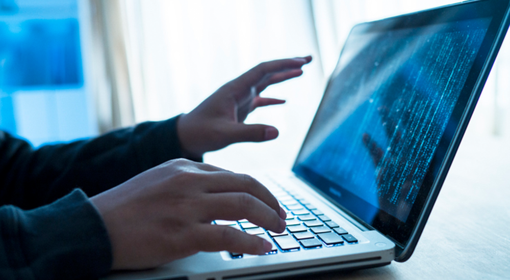 person coding on laptop